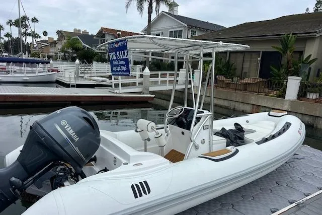 Slide: The Image of 2023 Novurania Como 18 boat docked, featuring Yamaha engine, for sale sign visible. - 3