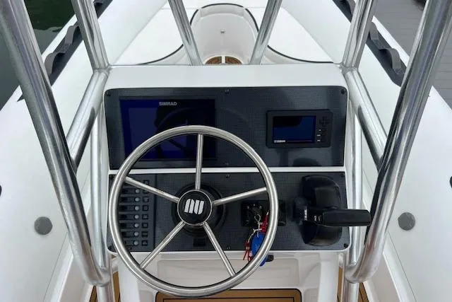 Slide: The Image of 2023 Novurania Como 18 boat dashboard with steering wheel and navigation controls. - 6