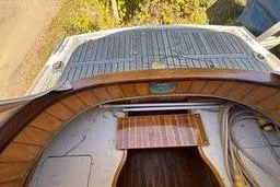 Slide: The Image of 2001 Logan 33 boat deck with wooden and metal details, viewed from above. - 12