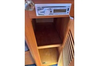 Slide: The Image of 2001 Logan 33 interior with wooden cabinet and built-in stereo system. - 16