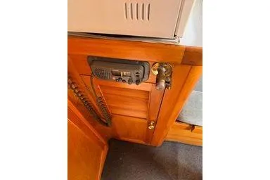 Slide: The Image of Wooden interior of 2001 Logan 33 boat with mounted radio equipment. - 17