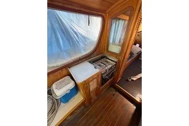 Slide: The Image of Interior of 2001 Logan 33 boat with wooden cabinetry and compact kitchen area. - 18