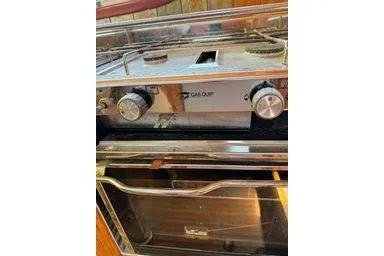 Slide: The Image of 2001 Logan 33 gas oven with dual burners and control knobs. - 20