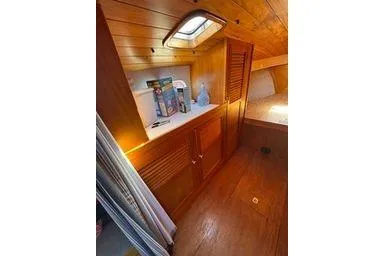Slide: The Image of Interior of 2001 Logan 33 boat with wooden cabinets and skylight. - 23