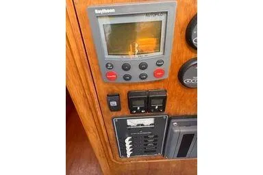 Slide: The Image of Control panel of 2001 Logan 33 boat with Raytheon display and switches. - 25