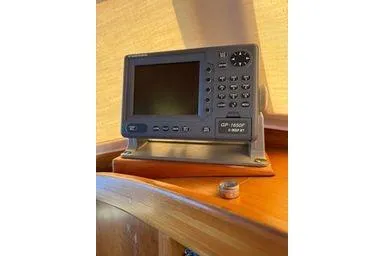 Slide: The Image of 2001 Logan 33 marine GPS device on wooden surface. - 27