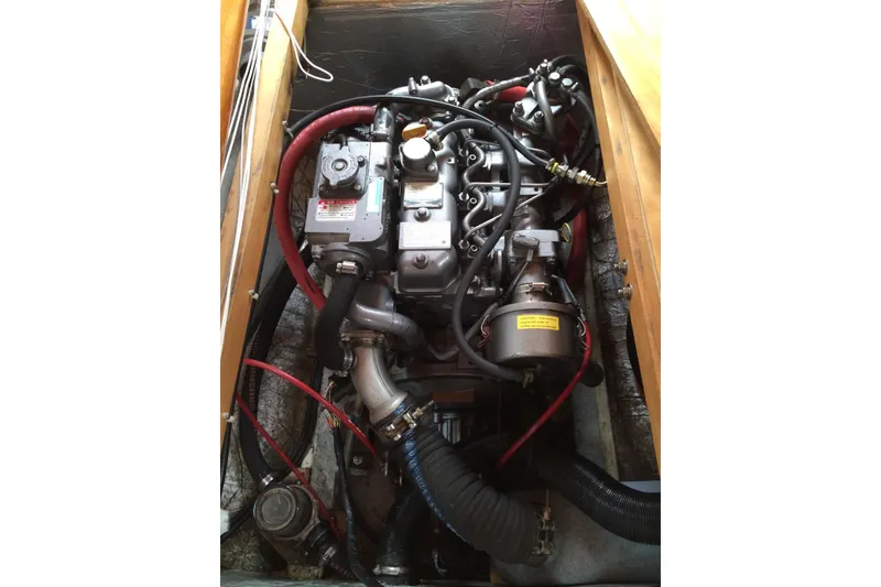 Slide: The Image of Engine compartment of a 2001 Logan 33 boat, featuring complex wiring and hoses. - 32