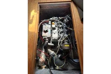 Slide: The Image of Engine compartment of a 2001 Logan 33, showcasing mechanical components and wiring. - 35