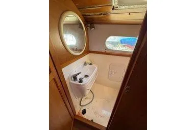 Slide: The Image of 2001 Logan 33 boat interior with sink and round mirror. - 36