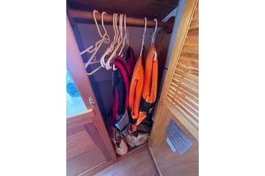 Slide: The Image of Closet interior with clothes and hangers in a 2001 Logan 33 model. - 37
