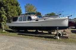 Slide: The Image of 2001 Logan 33 boat on dry dock, surrounded by trees and clear sky. - 5