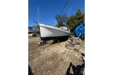 Slide: The Image of Sailboat Logan 33, 2001 model, on land with clear blue sky background. - 6