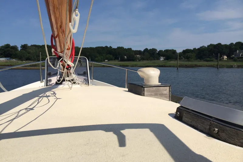 Slide: The Image of Sailboat deck view on water, Logan 33 model, 2001, with clear sky and shoreline. - 9