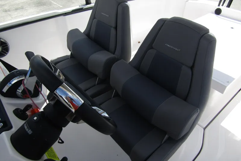 Slide: The Image of 2022 Axopar AX22TT boat interior with dual seats and steering wheel. - 11