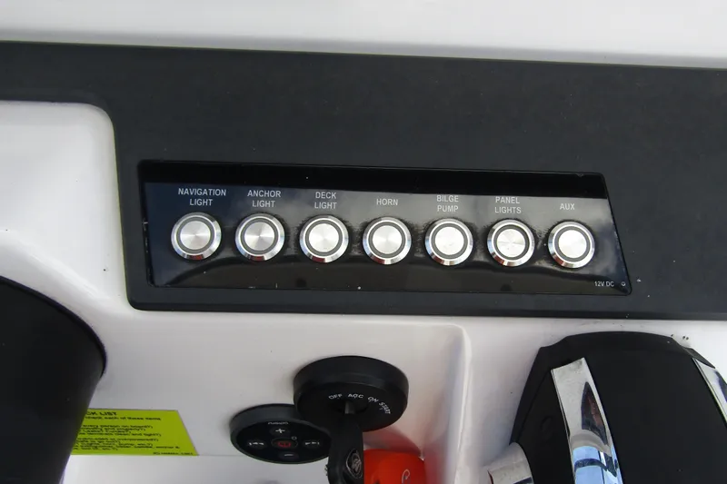 Slide: The Image of Control panel of 2022 Axopar AX22TT boat with labeled switches for various functions. - 14