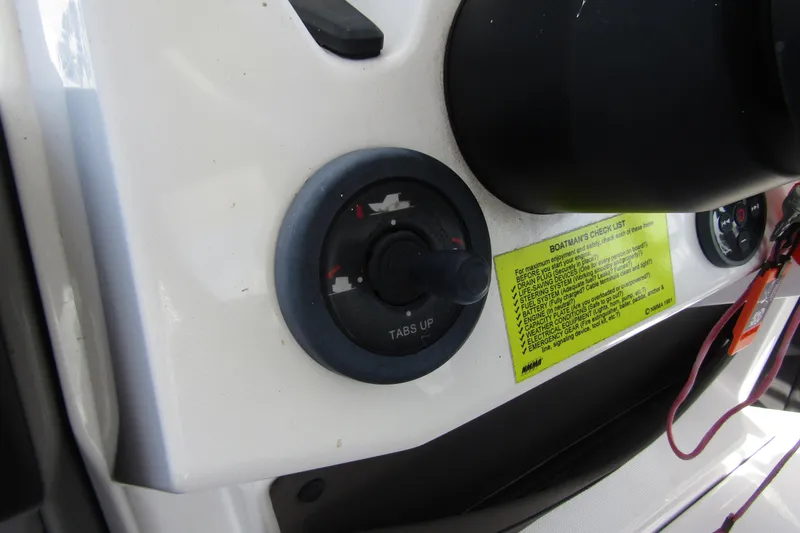 Slide: The Image of Control panel of 2022 Axopar AX22TT boat with checklist and trim tab switch. - 17