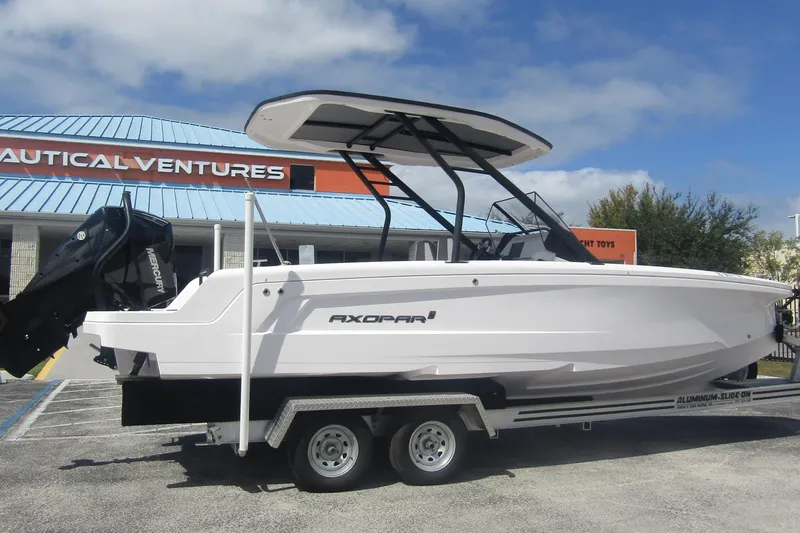 Slide: The Image of 2022 Axopar AX22TT boat on trailer at Nautical Ventures dealership. - 4