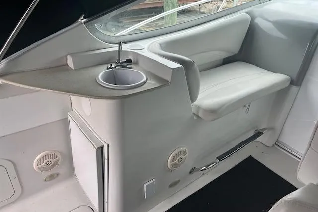 Slide: The Image of 2000 Four Winns 328 Vista boat interior with sink and seating area. - 10