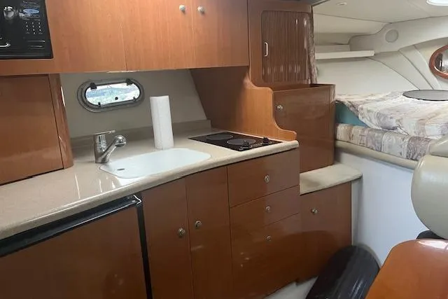Slide: The Image of 2000 Four Winns 328 Vista boat interior with kitchenette and bed. - 14