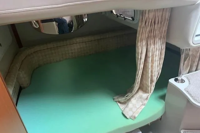 Slide: The Image of 2000 Four Winns 328 Vista cabin interior with bed and curtains. - 15