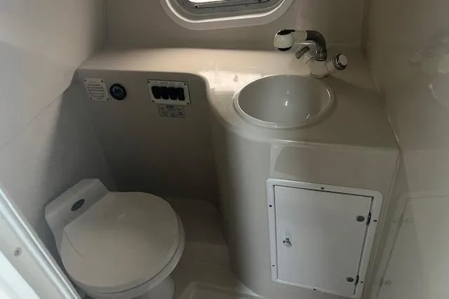 Slide: The Image of 2000 Four Winns 328 Vista boat bathroom with sink, toilet, and storage cabinet. - 17