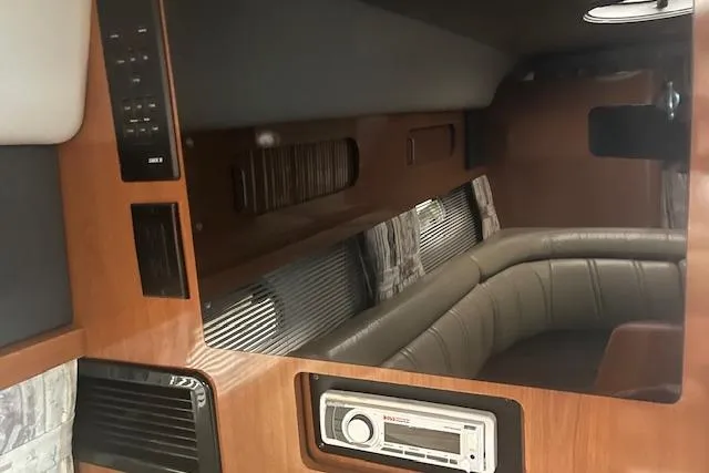 Slide: The Image of Interior of 2000 Four Winns 328 Vista boat with wood paneling and seating area. - 19