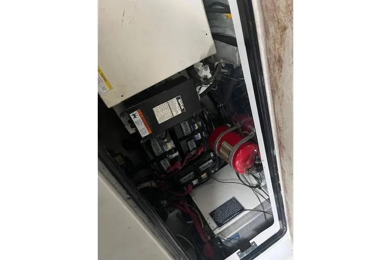 Slide: The Image of Engine compartment of 2000 Four Winns 328 Vista boat, showing batteries and fire extinguisher. - 22
