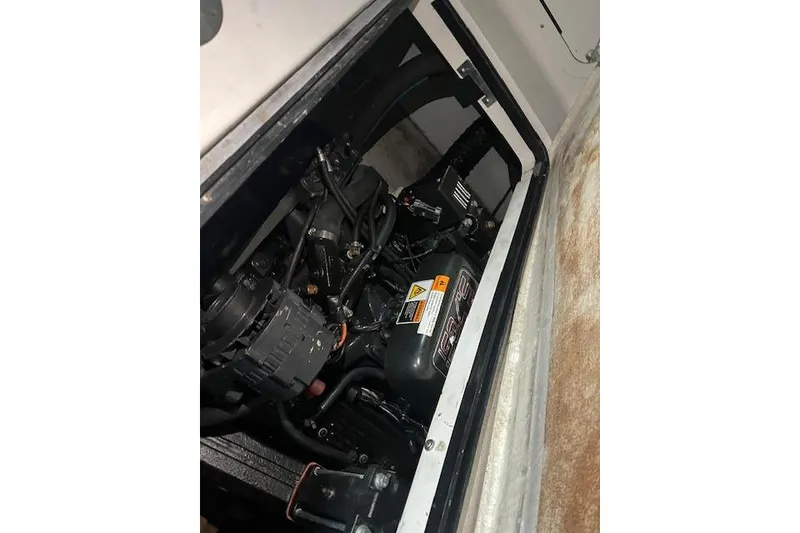 Slide: The Image of Engine compartment of a 2000 Four Winns 328 Vista boat, showcasing mechanical components. - 23