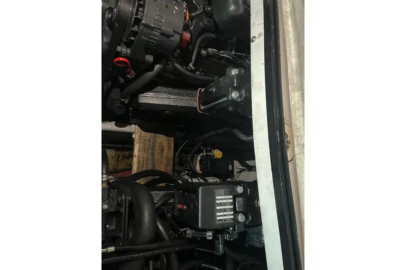 Slide: The Image of Engine compartment of a 2000 Four Winns 328 Vista boat, showcasing mechanical components. - 24