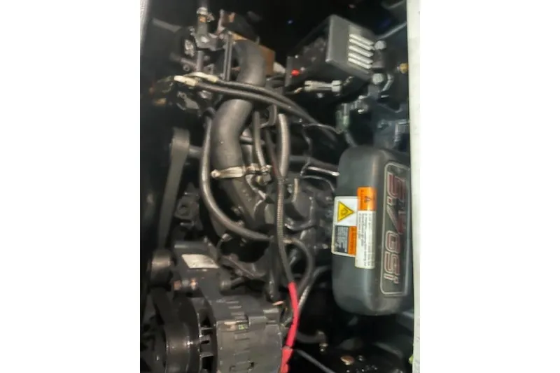 Slide: The Image of Engine compartment of a 2000 Four Winns 328 Vista boat, showcasing mechanical components. - 25
