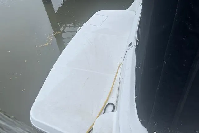 Slide: The Image of 2000 Four Winns 328 Vista boat docked, showing swim platform and water. - 3