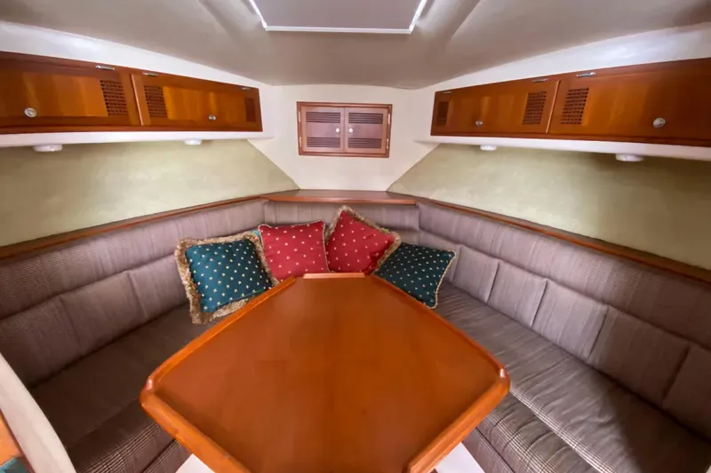 Slide: The Image of Interior of 1996 Cabo 31 Express boat with cozy seating and decorative cushions. - 10
