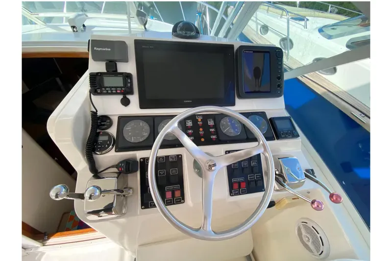 Slide: The Image of 1996 Cabo 31 Express helm with steering wheel, gauges, and navigation equipment. - 5