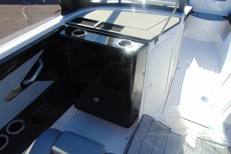 Slide: The Image of 2026 Yamaha Boats 222XD with blue exterior and tan seating, showcasing rear deck design. - 10