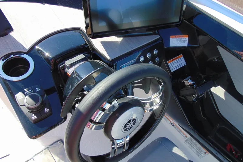 Slide: The Image of 2026 Yamaha Boats 222XD interior with tan and black seating, modern design, and spacious layout. - 12