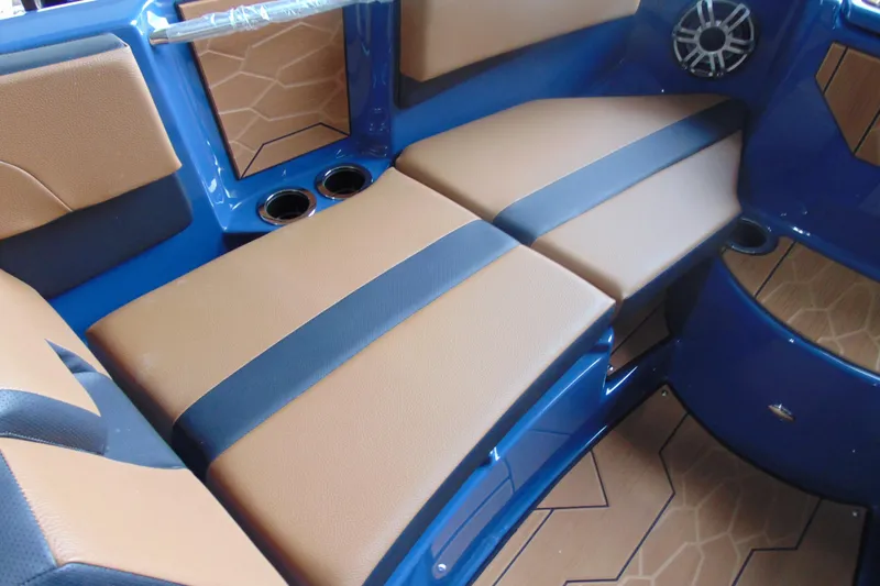 Slide: The Image of 2026 Yamaha Boats 222XD interior with tan and black seating, blue accents, and cup holders. - 18