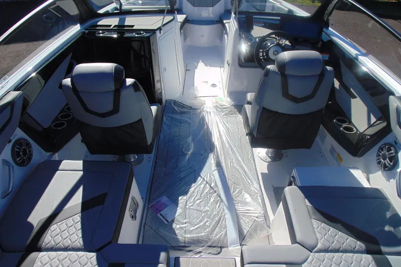 Slide: The Image of 2026 Yamaha Boats 222XD in showroom, sleek blue design on trailer. - 8