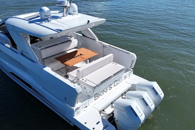 Slide: The Image of 2024 Jeanneau DB43 yacht with twin Mercury outboards, featuring a spacious deck and seating area. - 15