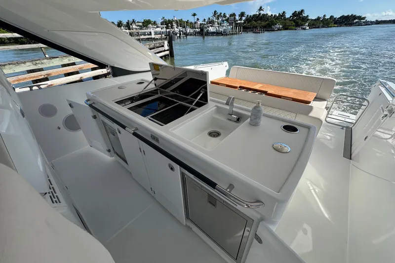 Slide: The Image of 2024 Jeanneau DB43 yacht with outdoor kitchen and scenic water view. - 22