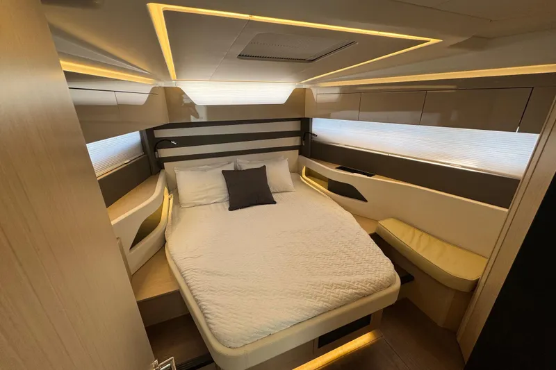 Slide: The Image of Luxurious cabin interior of 2024 Jeanneau DB43 yacht with modern lighting and cozy bedding. - 26