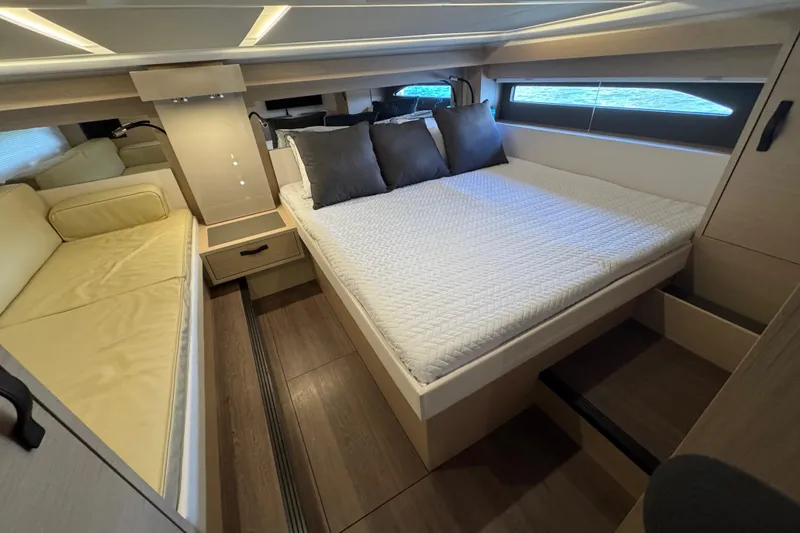 Slide: The Image of 2024 Jeanneau DB43 cabin interior with bed, sofa, and modern design. - 31