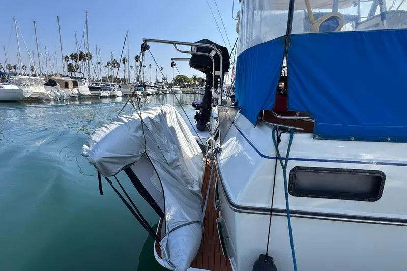 Slide: The Image of 1985 Carver 3607 Aft Cabin Motor Yacht docked with inflatable boat, marina background. - 12