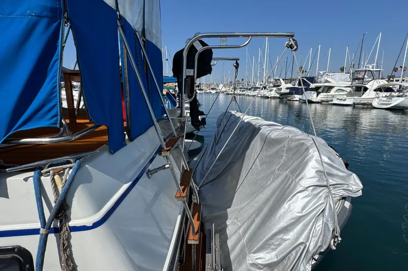 Slide: The Image of 1985 Carver 3607 Aft Cabin Motor Yacht docked in marina, blue canopy, covered dinghy. - 15