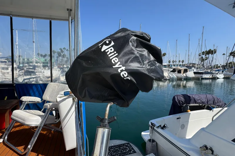 Slide: The Image of 1985 Carver 3607 Aft Cabin Motor Yacht docked, featuring covered equipment and marina view. - 17