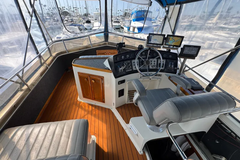 Slide: The Image of 1985 Carver 3607 Aft Cabin Motor Yacht helm with navigation equipment and seating. - 22