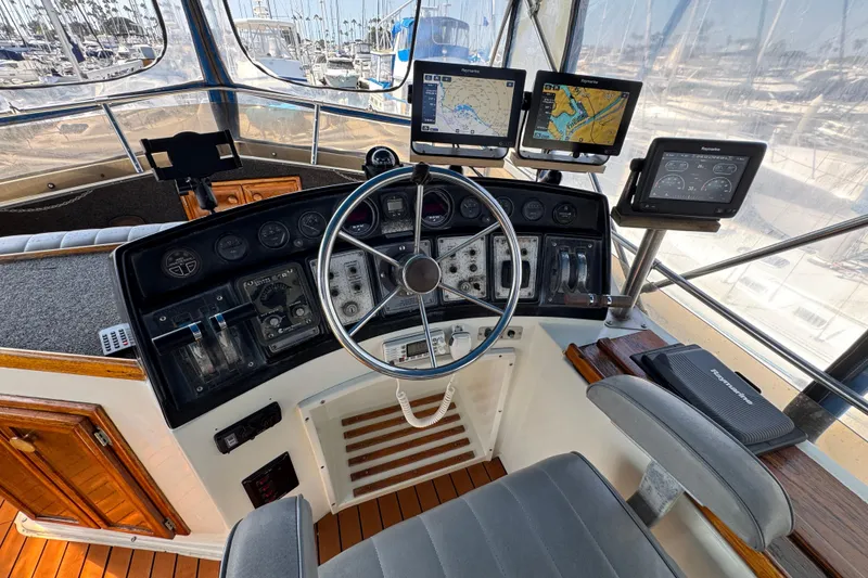 Slide: The Image of 1985 Carver 3607 Aft Cabin Motor Yacht helm with navigation equipment and steering wheel. - 23