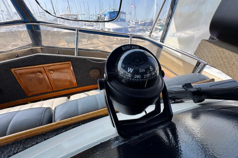 Slide: The Image of Compass on 1985 Carver 3607 Aft Cabin Motor Yacht, with marina view in background. - 28