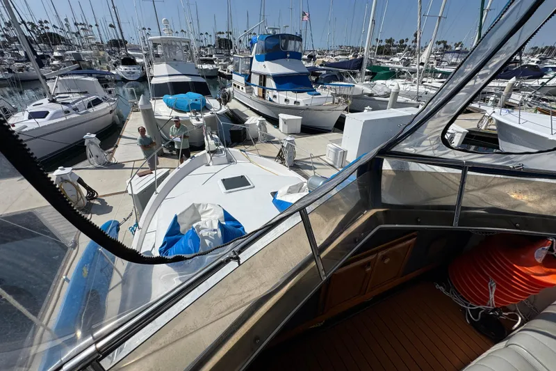 Slide: The Image of 1985 Carver 3607 Aft Cabin Motor Yacht docked in a busy marina. - 30