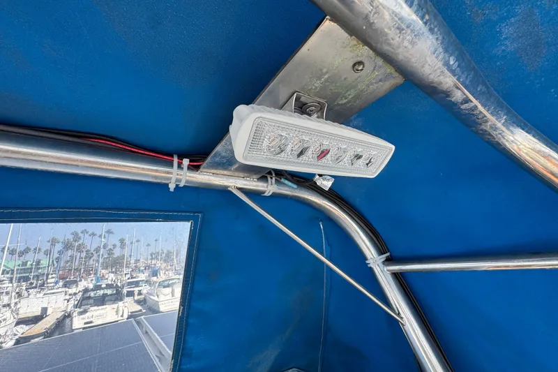 Slide: The Image of 1985 Carver 3607 Aft Cabin Motor Yacht interior with light fixture and marina view. - 34