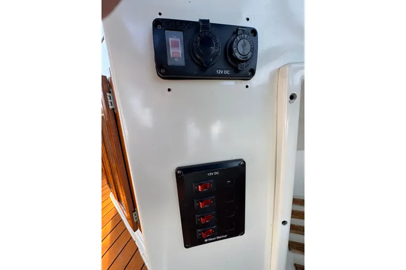 Slide: The Image of 1985 Carver 3607 Aft Cabin Motor Yacht 12V DC panel with switches and outlets. - 35